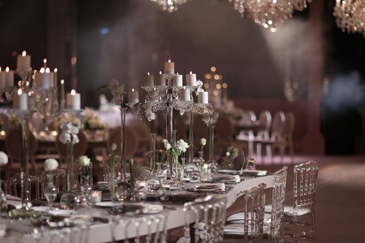 Elegant wedding reception setup with crystal candle holders and floral arrangements